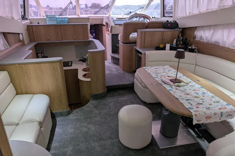  Yacht Photos Pics Luxurious interior of a 1998 Princess 52 Flybridge Motor Yacht with elegant seating and dining area.