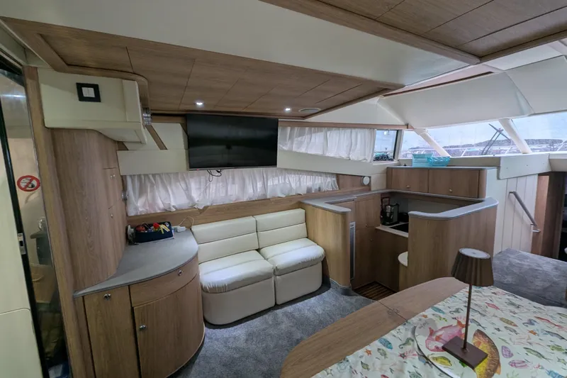  Yacht Photos Pics Luxurious interior of 1998 Princess 52 Flybridge Motor Yacht with modern amenities and cozy seating.