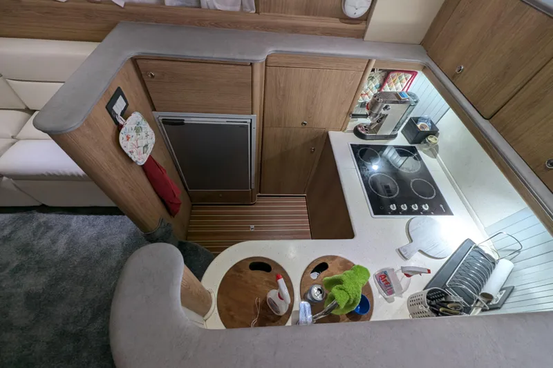  Yacht Photos Pics 1998 Princess 52 Flybridge Motor Yacht kitchen with modern appliances and wooden cabinetry.