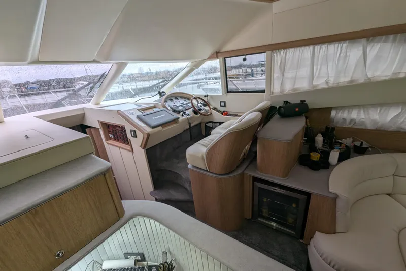  Yacht Photos Pics Interior of a 1998 Princess 52 Flybridge Motor Yacht, featuring helm and seating area.