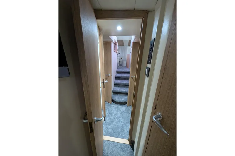  Yacht Photos Pics Interior hallway of 1998 Princess 52 Flybridge Motor Yacht with carpeted stairs.