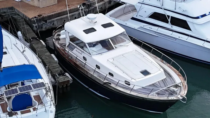  Yacht Photos Pics 2001 Apreamare 12m yacht docked at marina, surrounded by other boats.