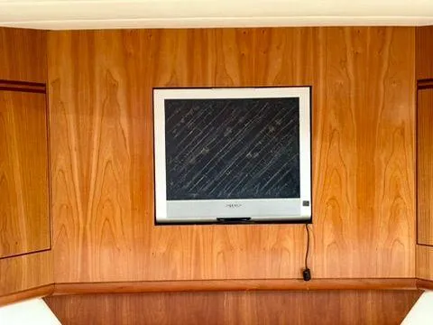  Yacht Photos Pics Wall-mounted TV on wooden paneling inside 2001 Apreamare 12m boat.