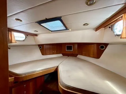  Yacht Photos Pics Interior cabin of 2001 Apreamare 12m yacht with wooden accents and skylight.