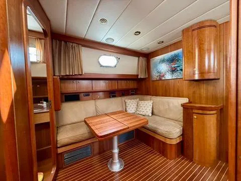  Yacht Photos Pics Luxurious interior of a 2001 Apreamare 12m yacht with wooden furnishings and cozy seating.