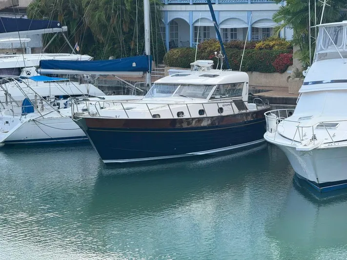  Yacht Photos Pics 2001 Apreamare 12m yacht docked between other boats in a marina.