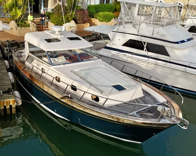  Yacht Photos Pics 2001 Apreamare 12m yacht docked at marina, featuring sleek design and classic wood accents.