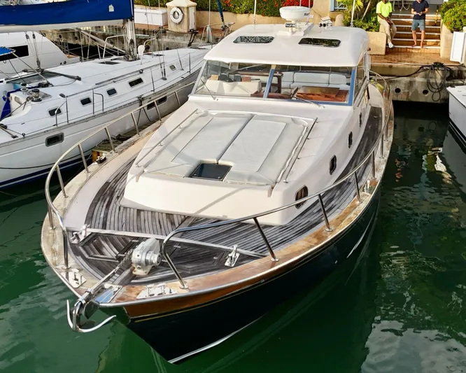  Yacht Photos Pics 2001 Apreamare 12m yacht docked in marina, featuring sleek design and wooden deck.