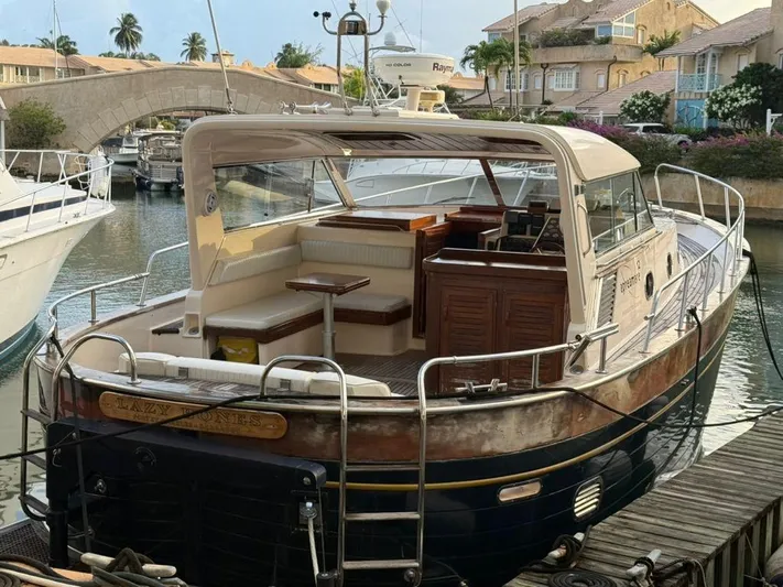  Yacht Photos Pics 2001 Apreamare 12m yacht docked in a scenic marina with bridge and houses.