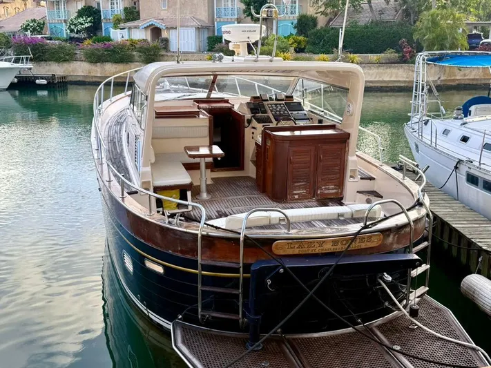  Yacht Photos Pics 2001 Apreamare 12m yacht docked in a serene marina setting.