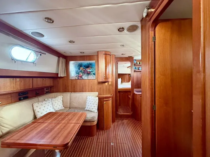  Yacht Photos Pics Luxurious interior of a 2001 Apreamare 12m yacht with wood finishes and cozy seating.