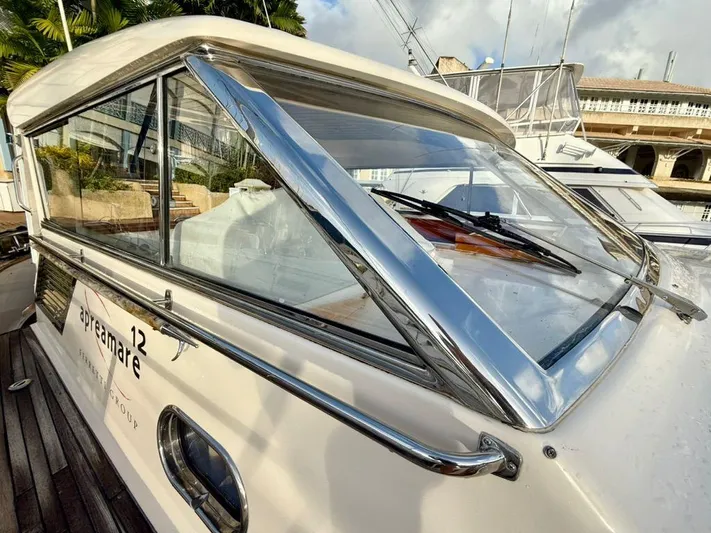  Yacht Photos Pics 2001 Apreamare 12m yacht with sleek design and polished chrome details, docked at marina.