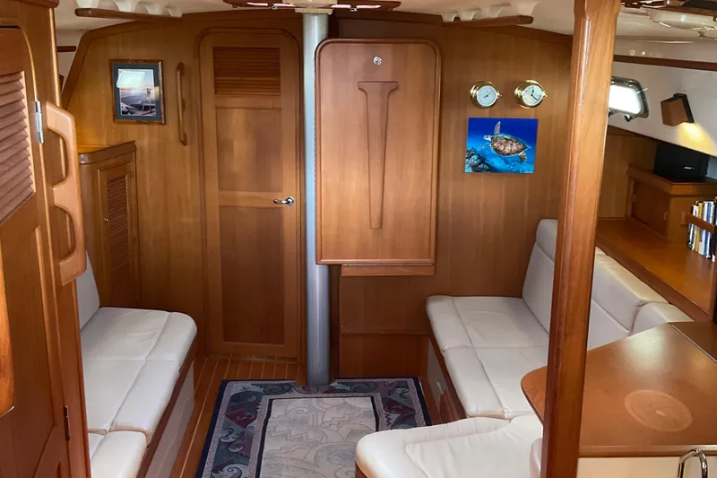 Petrel Yacht Photos Pics Interior of 2001 Island Packet 420 yacht with wooden finish and white seating.