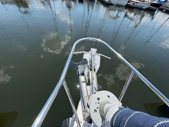 Ventosa Yacht Photos Pics Bow of a 2006 Catalina 350 sailboat with anchor and winch, docked in a marina.
