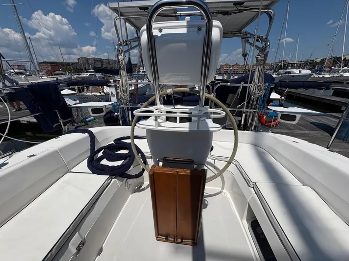 Ventosa Yacht Photos Pics Catalina 350 sailboat cockpit with steering wheel, docked in marina, clear sky.