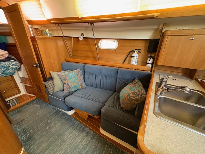 Ventosa Yacht Photos Pics Interior of a 2006 Catalina 350 sailboat with cozy seating and kitchenette.