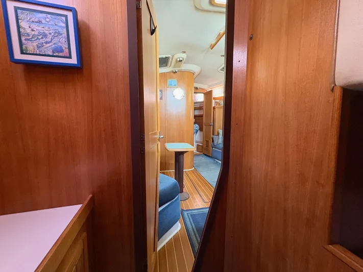 Ventosa Yacht Photos Pics Interior of a 2006 Catalina 350 sailboat, featuring wooden paneling and cozy seating.