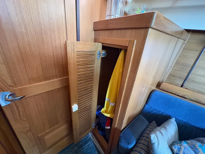 Ventosa Yacht Photos Pics Wooden interior of a 2006 Catalina 350 sailboat with open storage cabinet.