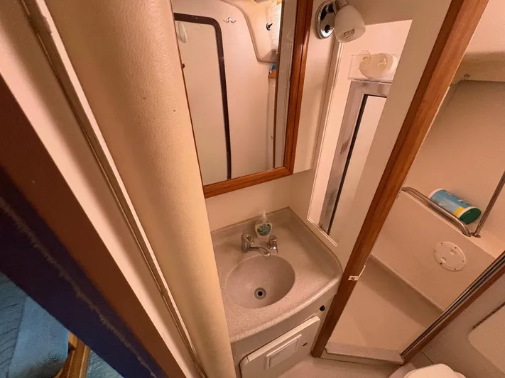 Ventosa Yacht Photos Pics Bathroom interior of a 2006 Catalina 350 sailboat, featuring a compact sink and mirror.