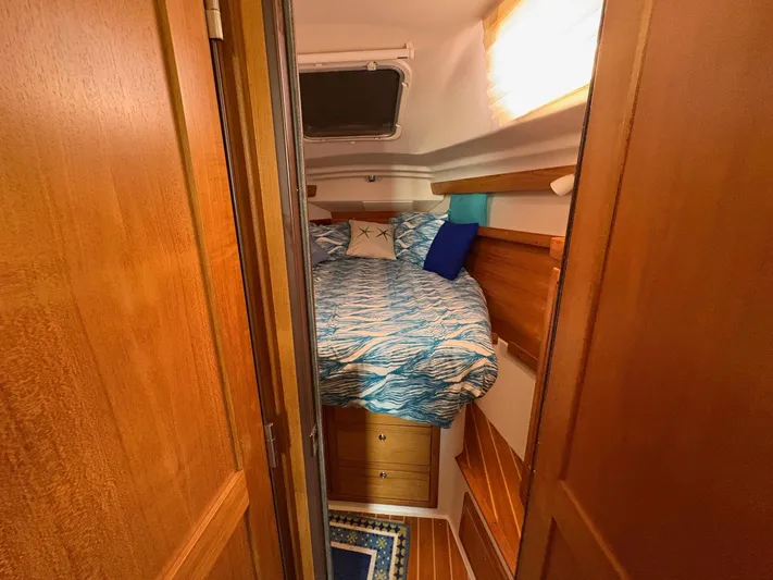 Ventosa Yacht Photos Pics Cozy cabin interior of 2006 Catalina 350 sailboat with wooden finish and nautical bedding.
