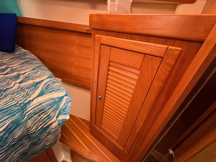 Ventosa Yacht Photos Pics Wooden interior of 2006 Catalina 350 sailboat with bed and storage cabinet.