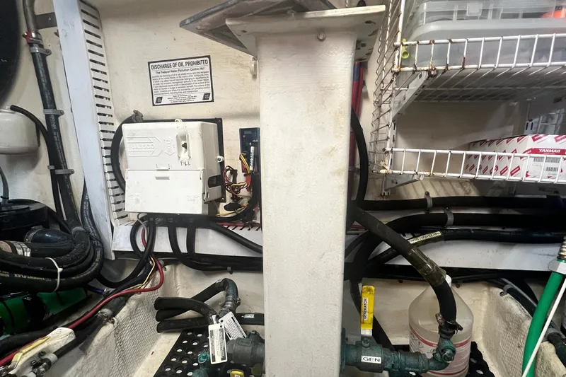 Insandity Yacht Photos Pics Engine room of 2006 Great Harbour N37 with wiring, pipes, and storage shelves.