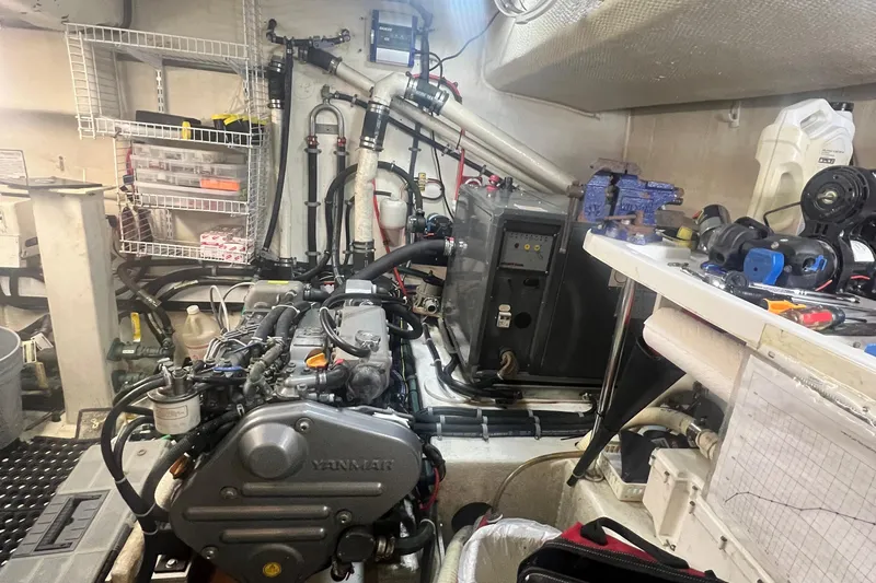 Insandity Yacht Photos Pics Engine room of a 2006 Great Harbour N37 boat, featuring a Yanmar engine and various tools.