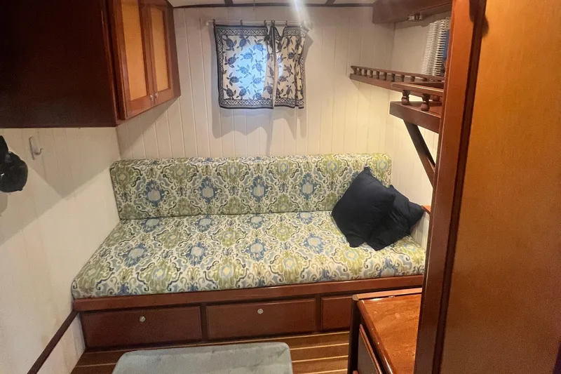 Insandity Yacht Photos Pics Cozy cabin interior of 2006 Great Harbour N37 with patterned sofa and wooden accents.