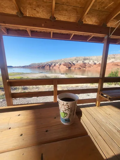 Mv Belle Yacht Photos Pics Covered deck with coffee overlooking scenic lake and red rock formations.