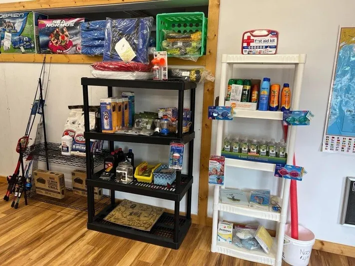 Mv Belle Yacht Photos Pics Fishing and boating supplies displayed on shelves in a store with wooden flooring.