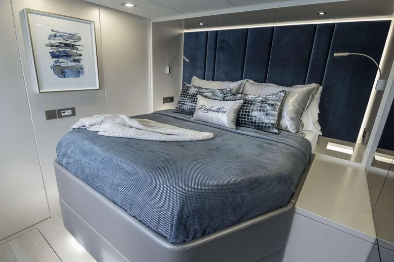 Relentless Yacht Photos Pics Luxurious bedroom interior of 2020 Sunreef Sail 60 yacht with elegant bedding and modern decor.