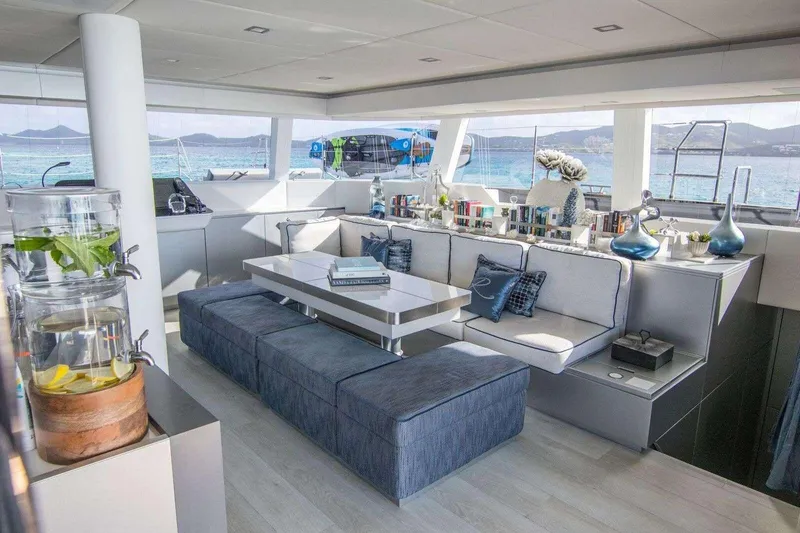 Relentless Yacht Photos Pics Luxurious interior of 2020 Sunreef Sail 60 yacht with elegant seating and ocean view.