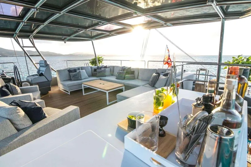 Relentless Yacht Photos Pics Luxurious Sunreef Sail 60 yacht deck with elegant seating and bar, 2020 model.
