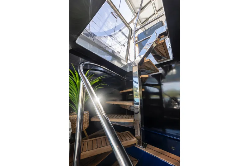 Relentless Yacht Photos Pics Modern staircase on 2020 Sunreef Sail 60 yacht with sleek design and natural light.
