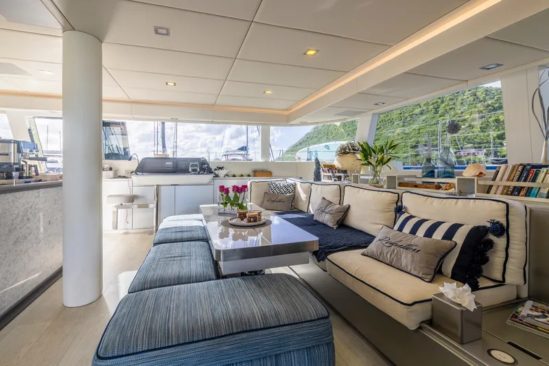 Relentless Yacht Photos Pics Luxurious interior of 2020 Sunreef Sail 60 yacht with elegant seating and scenic views.