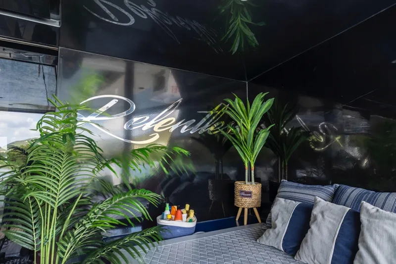 Relentless Yacht Photos Pics Luxurious interior of 2020 Sunreef Sail 60 yacht with elegant decor and greenery.