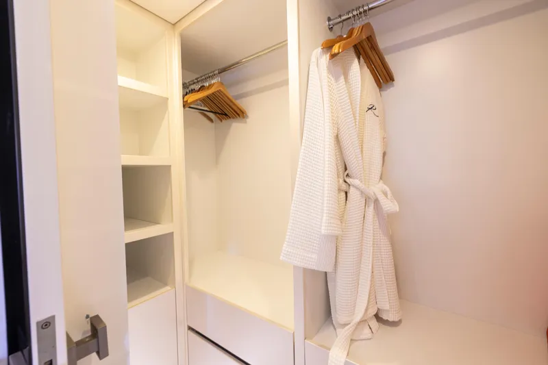 Relentless Yacht Photos Pics Luxurious Sunreef Sail 60 yacht closet with robe and hangers, 2020 model.