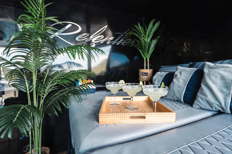 Relentless Yacht Photos Pics Luxurious Sunreef Sail 60 yacht interior with cocktails, cushions, and tropical plants, 2020 model.