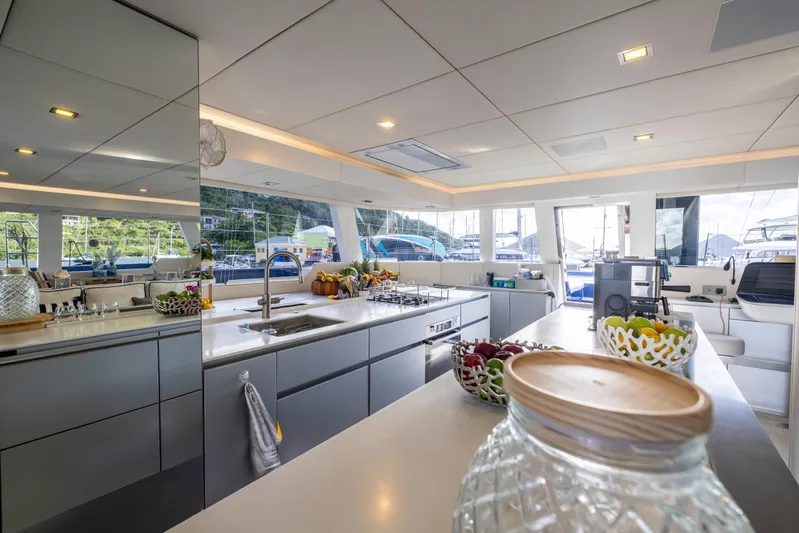 Relentless Yacht Photos Pics Luxurious Sunreef Sail 60 yacht kitchen interior, featuring modern design and marina views.