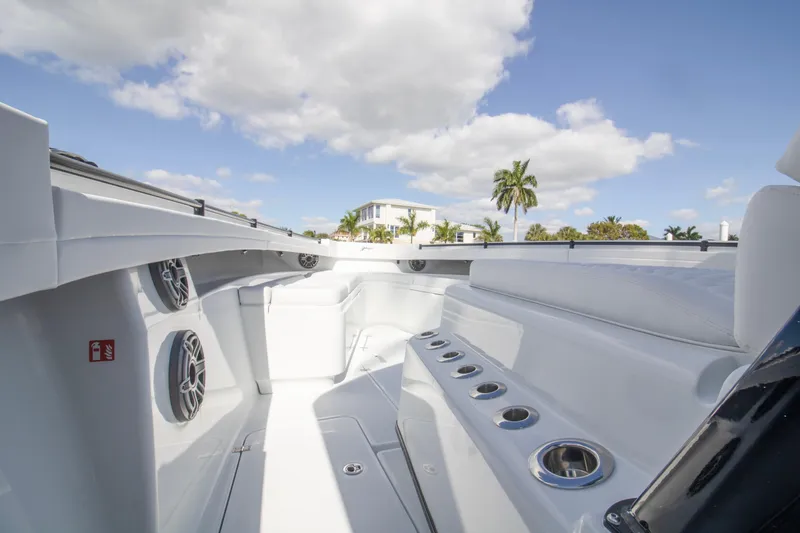  Yacht Photos Pics 2026 Yellowfin 42 Offshore boat interior with seating and cup holders under a blue sky.