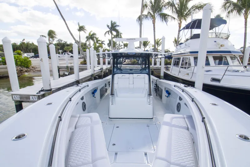  Yacht Photos Pics 2026 Yellowfin 42 Offshore boat docked at marina with palm trees.