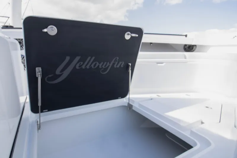  Yacht Photos Pics 2026 Yellowfin 42 Offshore boat storage compartment with open lid under a clear sky.