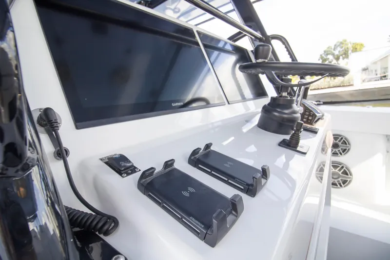  Yacht Photos Pics 2026 Yellowfin 42 Offshore boat dashboard with steering wheel and electronic controls.