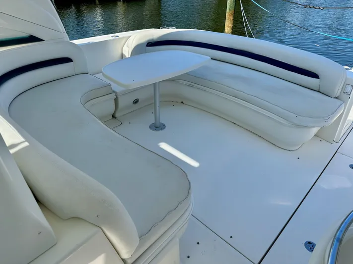 Alibi Yacht Photos Pics 2004 Sea Ray 420 Sundancer boat with white seating and table on deck.
