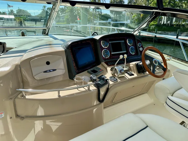 Alibi Yacht Photos Pics Helm of 2004 Sea Ray 420 Sundancer with modern controls and wood-accented steering wheel.