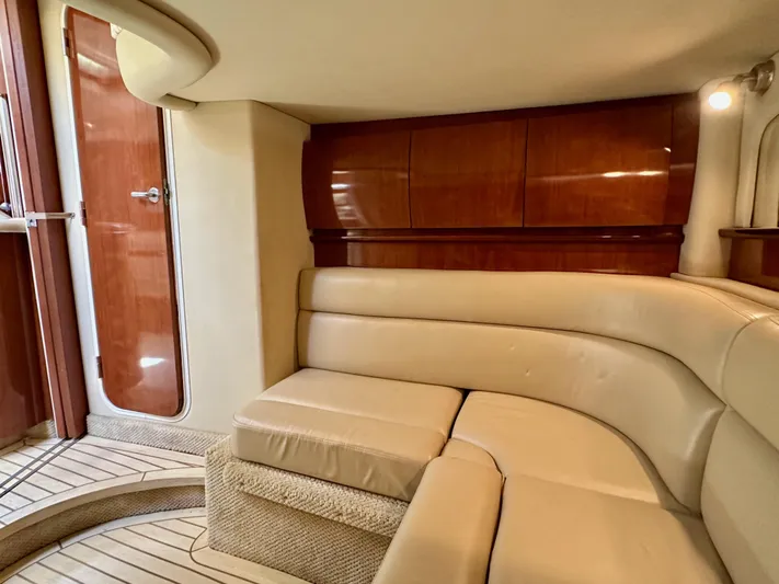 Alibi Yacht Photos Pics Luxurious interior of 2004 Sea Ray 420 Sundancer with beige seating and wooden accents.