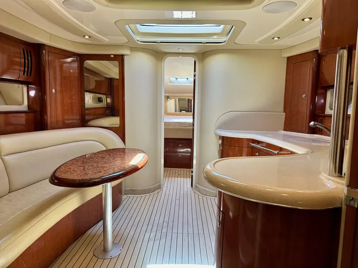 Alibi Yacht Photos Pics Luxurious interior of 2004 Sea Ray 420 Sundancer yacht with elegant wood finishes and modern amenities.