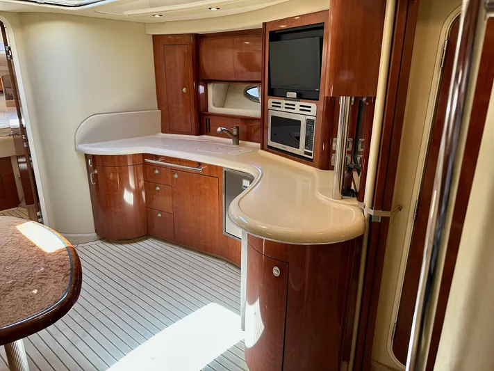 Alibi Yacht Photos Pics Luxurious 2004 Sea Ray 420 Sundancer yacht interior with elegant wood cabinetry and modern amenities.
