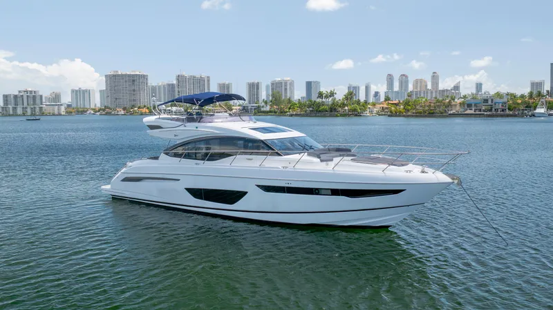 Yacht Photos Pics Luxurious 2017 Princess S65 yacht anchored in a scenic urban waterfront.