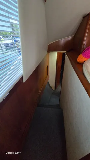  Yacht Photos Pics Interior hallway of 1997 Ocean Yachts 40 Super Sport with wooden paneling and carpeted floor.